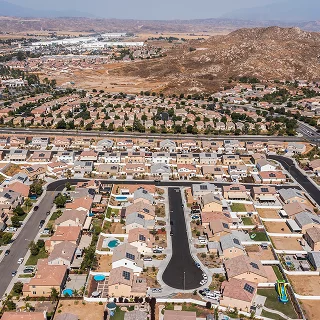 Daytime aerial view of a suburban neighborhood in Moreno Valley, California, USA.