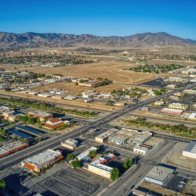 Aerial view of Palmdale, California with city streets, businesses, and mountain views in the Antelope Valley
