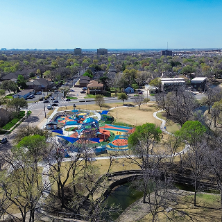 Colorful outdoor playground with climbing structures in Spring, Texas – cheap car insurance in Texas.