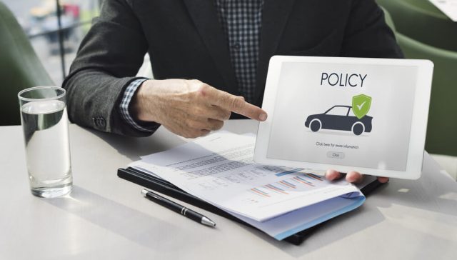 Insurance agent reviewing an auto policy and explaining ways to save on SR-22 insurance.