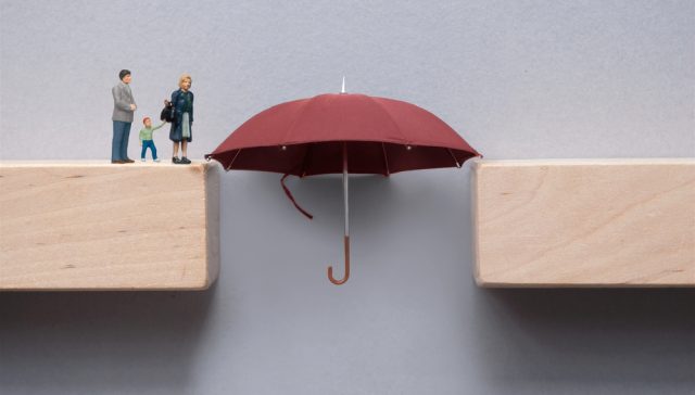 Family insurance gaps illustrated by umbrella bridging a gap between two platforms