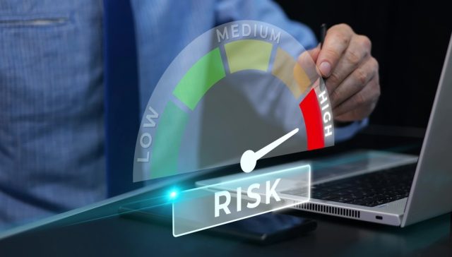 Person reviewing a high-risk indicator on a laptop while comparing high-risk auto insurance quotes.
